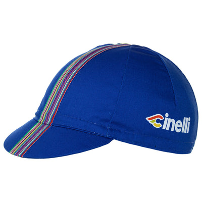 Side of the Cinelli Ciao Blue Cotton Cycling Cap. The Cinelli logo is printed on the side and that wonderful multicoloured woven twill ribbon down the centre.